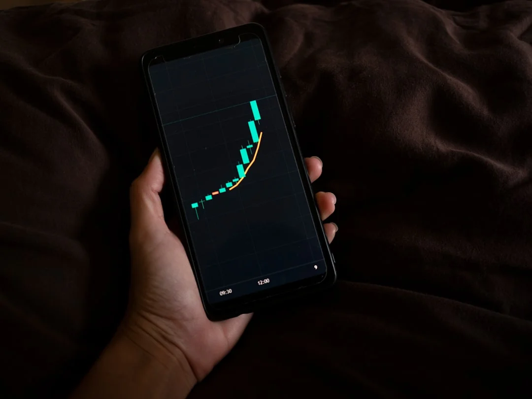 Focused image of hands analyzing business graphs and charts in a folder, highlighting data insights.